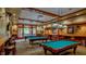 Spacious billiards room features wood trim, multiple tables, bar seating, and classic lighting at 803 Footbridge Pl, Cary, NC 27519