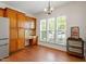 Charming breakfast nook featuring wood cabinets, hardwood floors, and bright natural light from the three windows at 803 Footbridge Pl, Cary, NC 27519