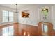 Bright dining room with hardwood floors, decorative moldings and window overlooking the lawn and driveway at 803 Footbridge Pl, Cary, NC 27519