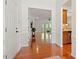 Inviting foyer with hardwood floors, white wainscoting, and views into the living spaces at 803 Footbridge Pl, Cary, NC 27519