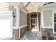 Close-up of the home's front entrance featuring stone accents and classic architectural details at 803 Footbridge Pl, Cary, NC 27519
