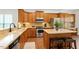 Well-equipped kitchen with wood cabinets, stainless steel appliances, and a center island at 803 Footbridge Pl, Cary, NC 27519