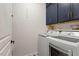 Laundry room with new washer and dryer and blue cabinets at 803 Footbridge Pl, Cary, NC 27519