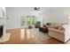 Spacious living room featuring hardwood floors, fireplace, and a comfortable seating arrangement at 803 Footbridge Pl, Cary, NC 27519