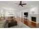 Comfortable living room with hardwood floors, fireplace, and a view to the kitchen at 803 Footbridge Pl, Cary, NC 27519