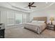 Relaxing main bedroom featuring soft carpet, tray ceiling, and a neutral color scheme at 803 Footbridge Pl, Cary, NC 27519