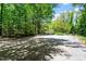 An expansive outdoor court provides recreational opportunities in a lush backyard at 803 Old Mill Rd, Chapel Hill, NC 27514