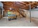 Unfinished basement with a pool table and open ceiling with support beams at 803 Old Mill Rd, Chapel Hill, NC 27514