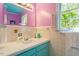 Colorful bathroom with turquoise vanity and bright lighting, adding a cheerful touch at 803 Old Mill Rd, Chapel Hill, NC 27514
