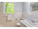 Well-lit bathroom featuring tiled walls, window, and a classic sink at 803 Old Mill Rd, Chapel Hill, NC 27514