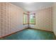 Cozy bedroom features vintage floral wallpaper, wood trim, and natural light at 803 Old Mill Rd, Chapel Hill, NC 27514