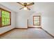 Bright bedroom featuring multiple windows, neutral walls, and carpet flooring at 803 Old Mill Rd, Chapel Hill, NC 27514