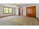 Bright bedroom featuring a large window, carpet flooring and closet at 803 Old Mill Rd, Chapel Hill, NC 27514