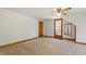 Cozy bedroom with a ceiling fan, door to balcony and carpet flooring at 803 Old Mill Rd, Chapel Hill, NC 27514