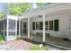 Home's covered porch showing seating, green shutters, and easy access to the screened porch at 803 Old Mill Rd, Chapel Hill, NC 27514