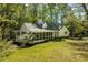 Charming home with a screened porch, lush greenery, and inviting curb appeal at 803 Old Mill Rd, Chapel Hill, NC 27514
