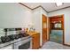 Galley kitchen includes stainless steel stove and lots of natural light at 803 Old Mill Rd, Chapel Hill, NC 27514