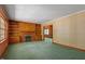 Inviting living room with a brick fireplace, built-in shelving, and wood paneling at 803 Old Mill Rd, Chapel Hill, NC 27514