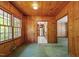 Cozy living room featuring wood walls, green carpet, and easy access to the kitchen at 803 Old Mill Rd, Chapel Hill, NC 27514