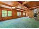 Spacious living room with wood-paneled walls, wood ceiling, and a stone fireplace at 803 Old Mill Rd, Chapel Hill, NC 27514
