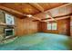 Inviting living room with a stone fireplace, wood paneling, and natural light at 803 Old Mill Rd, Chapel Hill, NC 27514