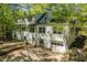 Expansive two-story home with a brick exterior, a wooden deck and upper balcony at 803 Old Mill Rd, Chapel Hill, NC 27514