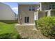 Backyard features a patio with table, lush grass, and a sliding glass door entrance to the home at 8520 Quarton Dr, Raleigh, NC 27616