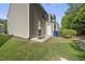 A quaint backyard featuring a patio with outdoor seating, bins, and lush green grass at 8520 Quarton Dr, Raleigh, NC 27616