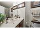 Cozy bathroom featuring a vessel sink, dark wood cabinetry, and framed artwork at 8520 Quarton Dr, Raleigh, NC 27616