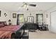 Dark bedroom with plush carpet, decorative ceiling fan, and a sleek black dresser at 8520 Quarton Dr, Raleigh, NC 27616