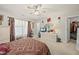 Bright bedroom with plush carpet, closet and a television on top of the dresser at 8520 Quarton Dr, Raleigh, NC 27616