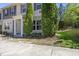 Exterior view of a two-story townhouse boasting manicured greenery and concrete driveway on a sunny day at 8520 Quarton Dr, Raleigh, NC 27616