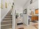Bright foyer with carpeted stairs, tile entry, and an open view into the living area and kitchen at 8520 Quarton Dr, Raleigh, NC 27616