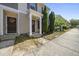 Inviting townhome entrance with a covered porch, seasonal decor, and neat landscaping at 8520 Quarton Dr, Raleigh, NC 27616
