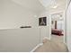 Upstairs hallway leading to a bedroom and closet space, showcasing natural light at 8520 Quarton Dr, Raleigh, NC 27616