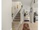 A carpeted staircase landing featuring a tile floor, leading to the upper level and an airy living space at 8520 Quarton Dr, Raleigh, NC 27616