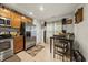 Eat-in kitchen features stainless appliances, wood cabinets, and natural light from a window view at 8520 Quarton Dr, Raleigh, NC 27616