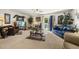 Spacious living room with plush carpet, a ceiling fan, and sliding glass doors to the outside at 8520 Quarton Dr, Raleigh, NC 27616