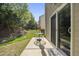 A patio area features a glass table with seating, offering a tranquil outdoor space with lush greenery at 8520 Quarton Dr, Raleigh, NC 27616