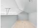 Unfinished attic space with sloped ceilings and recessed lighting offers potential for customization at 905 Cindy St, Cary, NC 27511