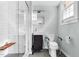 Modern bathroom with a glass shower, a floating vanity, and handicap railing at 905 Cindy St, Cary, NC 27511