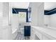 Stylish bathroom featuring navy accent wall, sink, vanity, and a decorative tile floor at 905 Cindy St, Cary, NC 27511