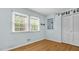 Bright bedroom with two windows and beautiful hardwood floors, offering a cozy and inviting space at 905 Cindy St, Cary, NC 27511