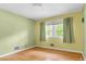 Cozy bedroom featuring hardwood floors, a bright window, and vibrant yellow walls, creating a warm and inviting atmosphere at 905 Cindy St, Cary, NC 27511