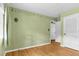 Spacious bedroom with hardwood floors, a bright window, and a soft green wall, creating a soothing and inviting atmosphere at 905 Cindy St, Cary, NC 27511