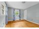 Well-lit bedroom with hardwood floors, complemented by two windows and stylish curtains for a comfortable ambiance at 905 Cindy St, Cary, NC 27511