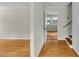 Inviting entryway showcasing hardwood floors, neutral walls, and a glimpse into an adjacent sunlit room at 905 Cindy St, Cary, NC 27511