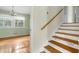 View of the home's entryway featuring wooden stairs and hardwood floors into the adjacent living area at 905 Cindy St, Cary, NC 27511