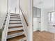 View of the home's entryway featuring wooden stairs and access to the utility room at 905 Cindy St, Cary, NC 27511