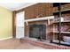 Close-up of the charming brick fireplace with wooden shelving, perfect for cozy evenings at 905 Cindy St, Cary, NC 27511